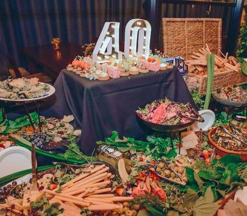 Catered party spread with platters and desserts